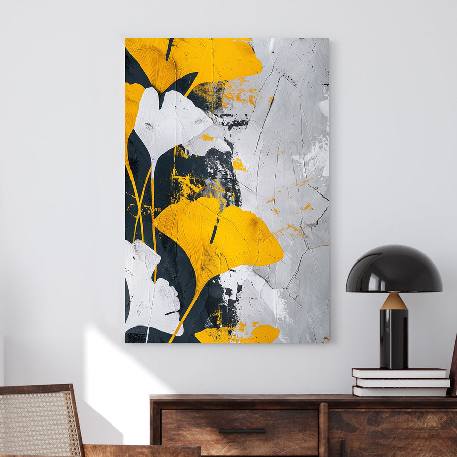 Abstract wall art of golden-yellow ginkgo leaves against a black, white, and grey textured background.