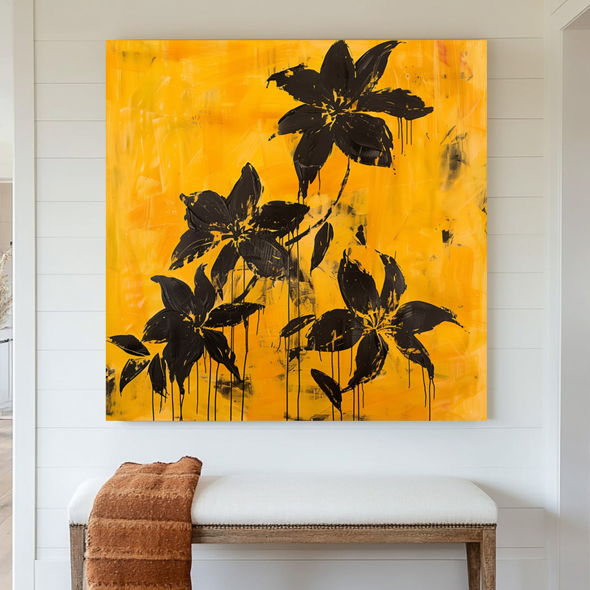 Abstract black floral wall art with dripping petals on a textured golden yellow background.