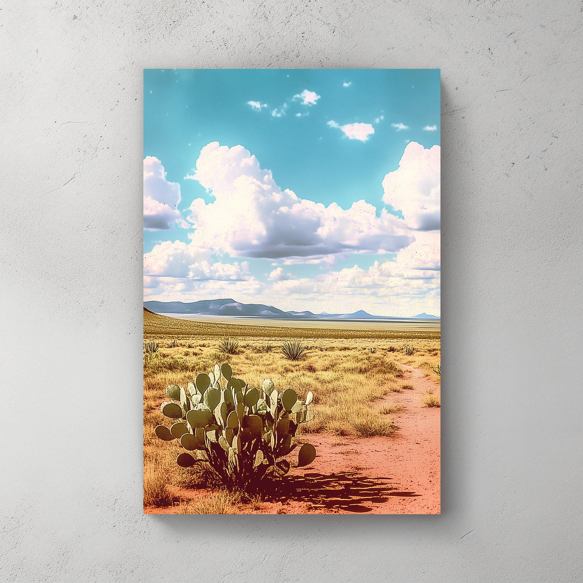 Vintage-style desert landscape with a prickly pear cactus, golden sand, distant mountains, and a vast blue sky filled with fluffy clouds.