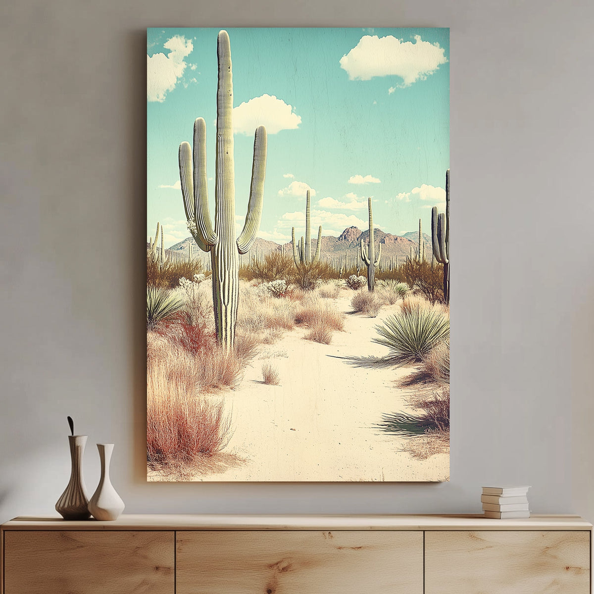 Vintage-style desert landscape featuring towering saguaro cacti, golden sand, and distant mountains under a pale blue sky.