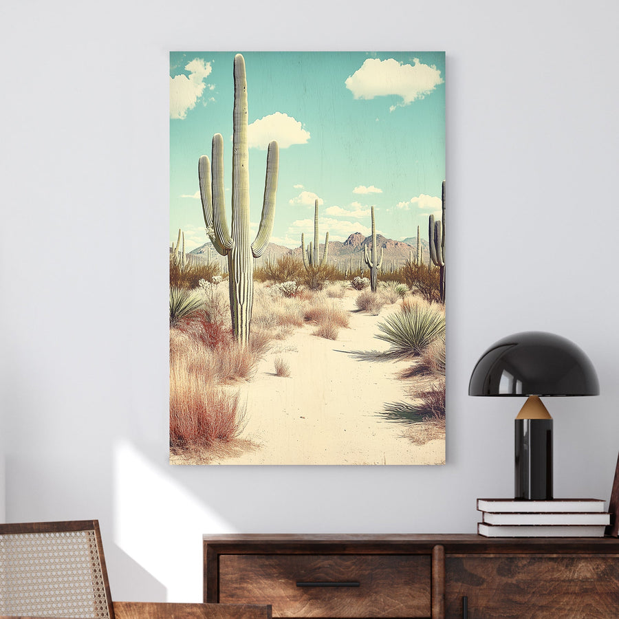 Vintage-style desert landscape featuring towering saguaro cacti, golden sand, and distant mountains under a pale blue sky.