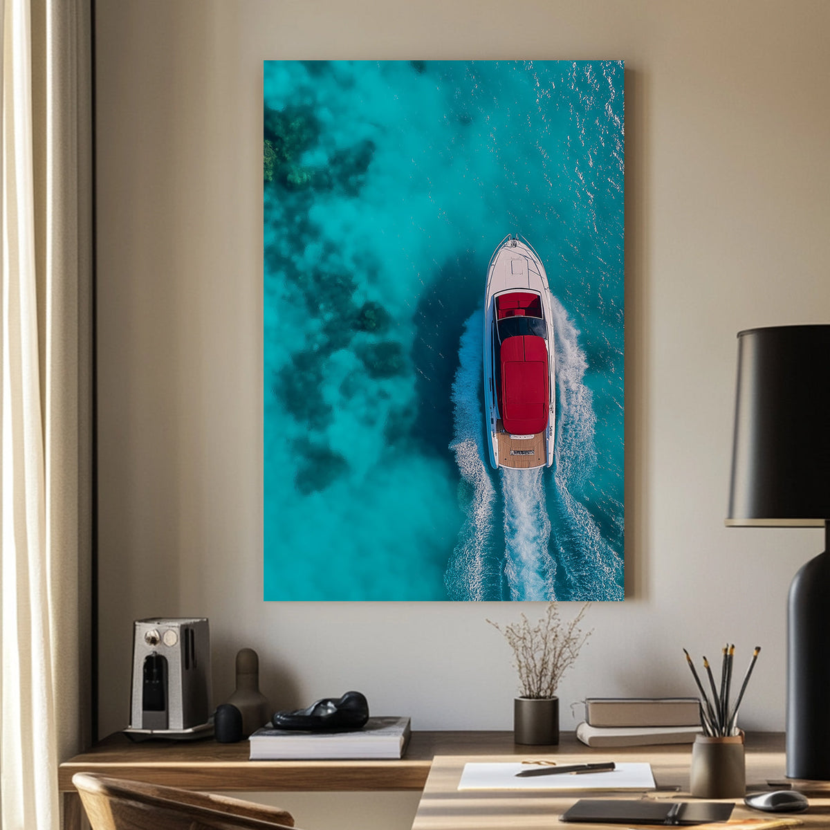 Aerial view of a white yacht with a red canopy cruising through turquoise ocean waters, leaving a foamy wake.