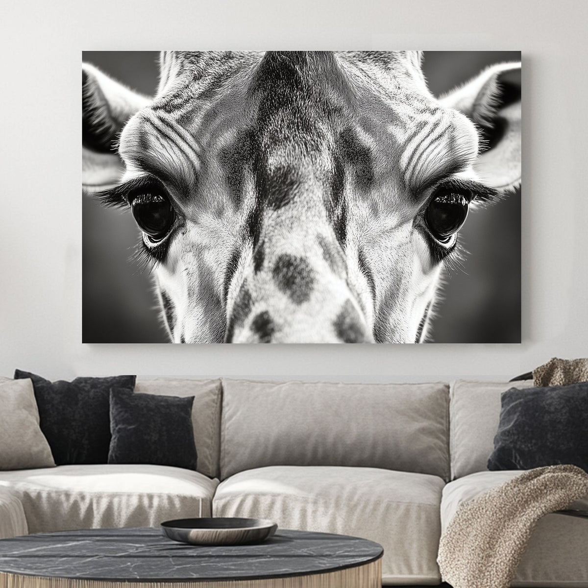 Black and white close-up portrait of a giraffe, focusing on its eyes and textured fur.
