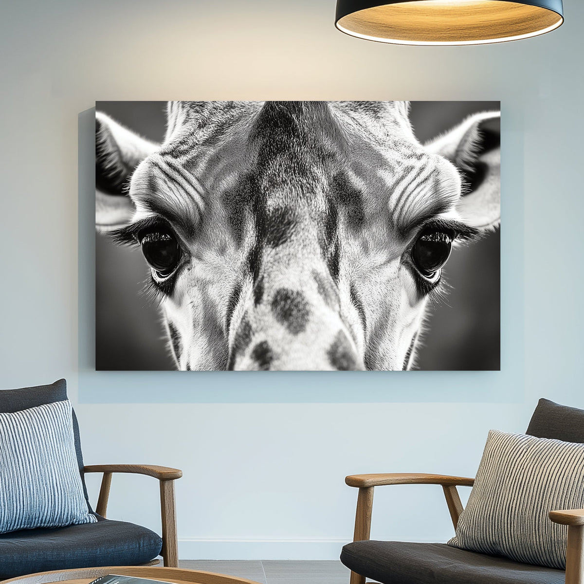 Black and white close-up portrait of a giraffe, focusing on its eyes and textured fur.