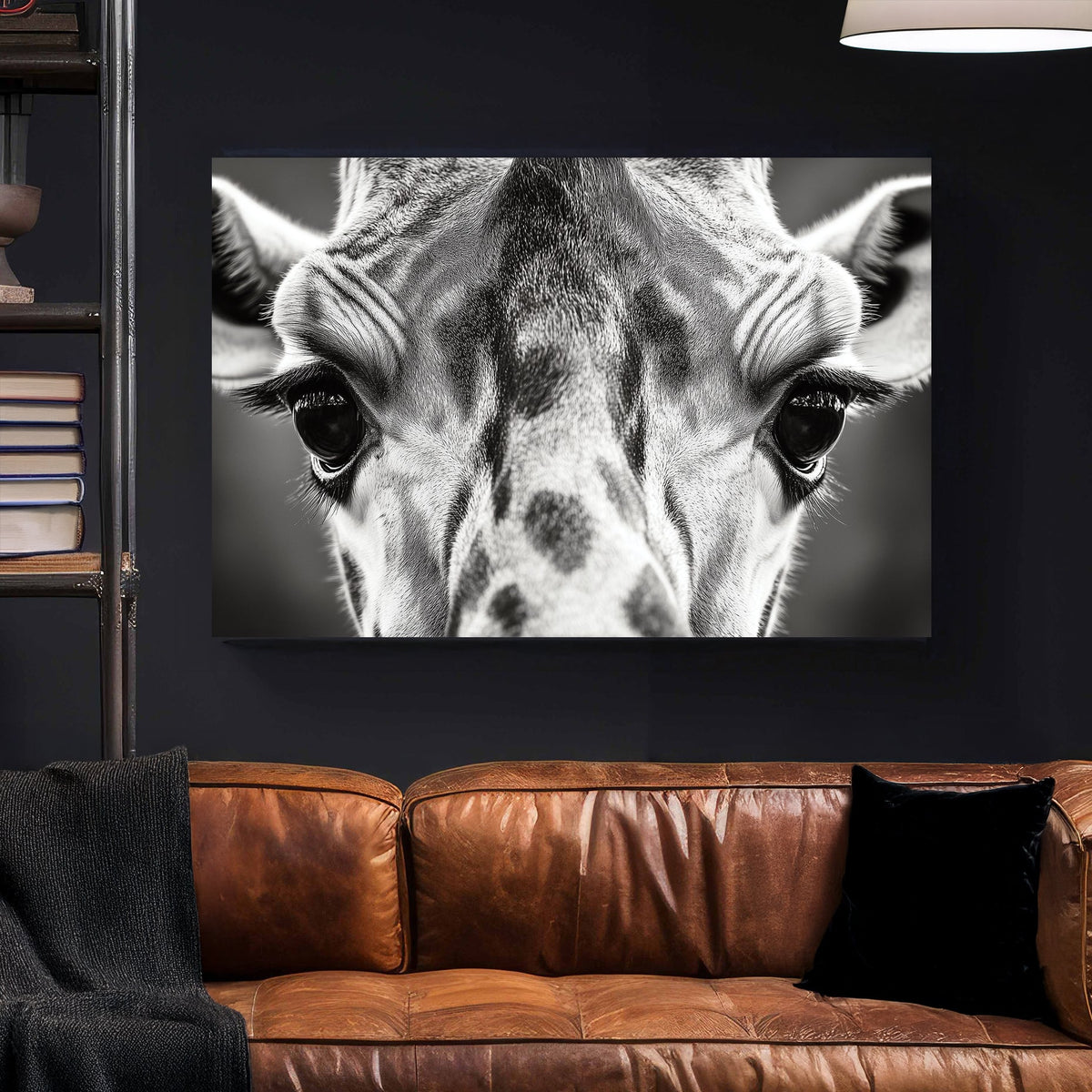 Black and white close-up portrait of a giraffe, focusing on its eyes and textured fur.