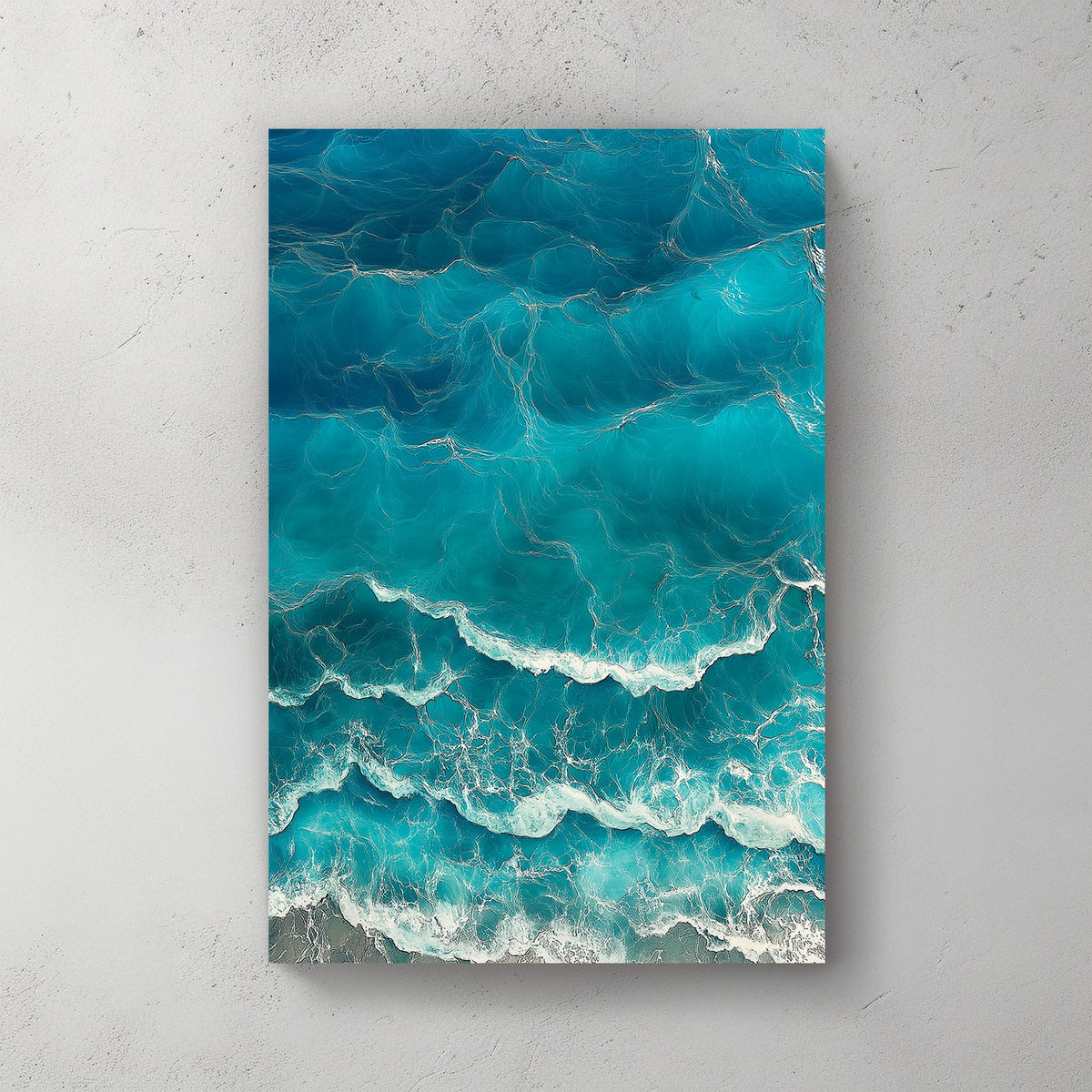 Aerial view of ocean waves rolling onto the shore, featuring deep blue hues and white foamy textures.