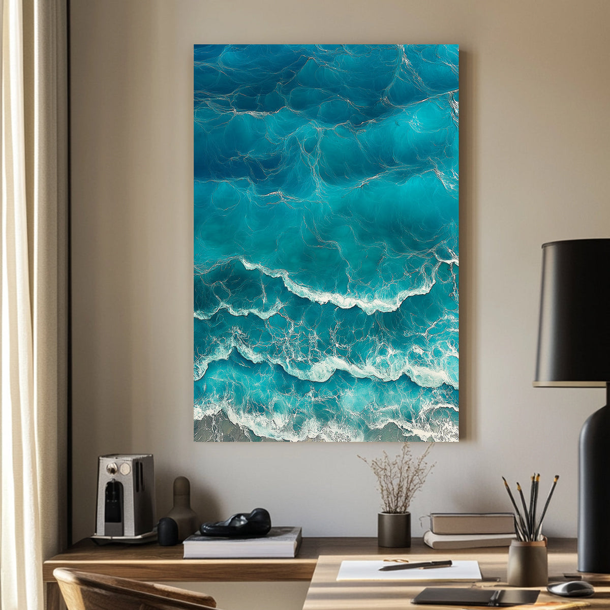 Aerial view of ocean waves rolling onto the shore, featuring deep blue hues and white foamy textures.