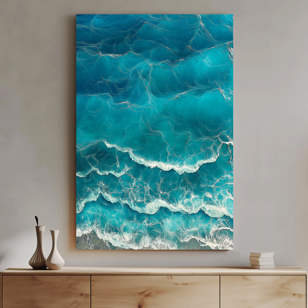 Aerial view of ocean waves rolling onto the shore, featuring deep blue hues and white foamy textures.