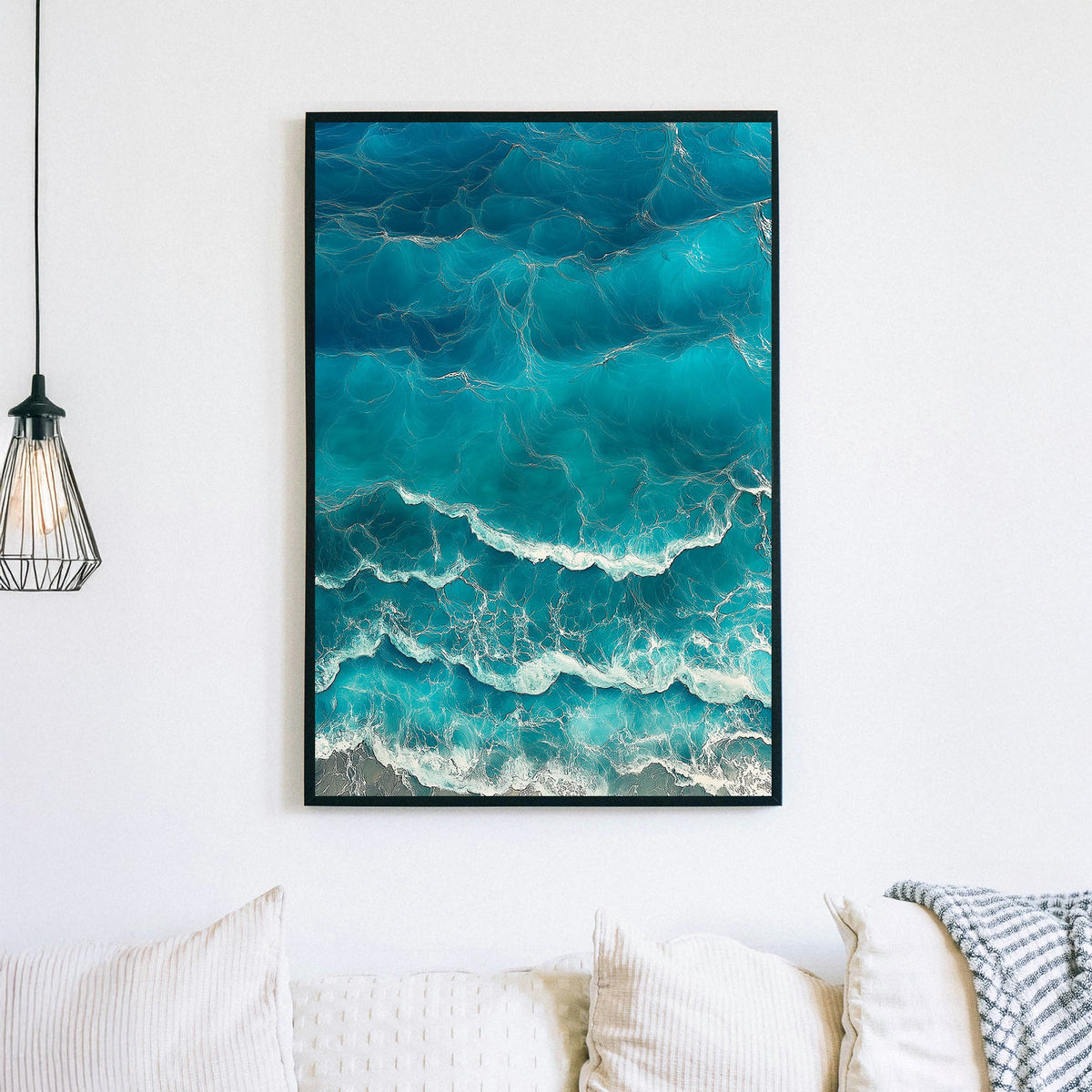 Aerial view of ocean waves rolling onto the shore, featuring deep blue hues and white foamy textures.