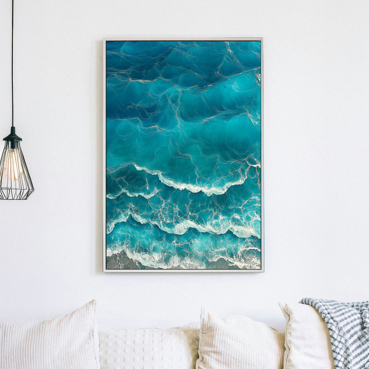 Aerial view of ocean waves rolling onto the shore, featuring deep blue hues and white foamy textures.