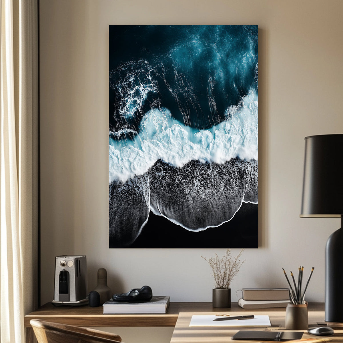 Aerial ocean wall art with deep blue waves crashing onto a black sand beach.