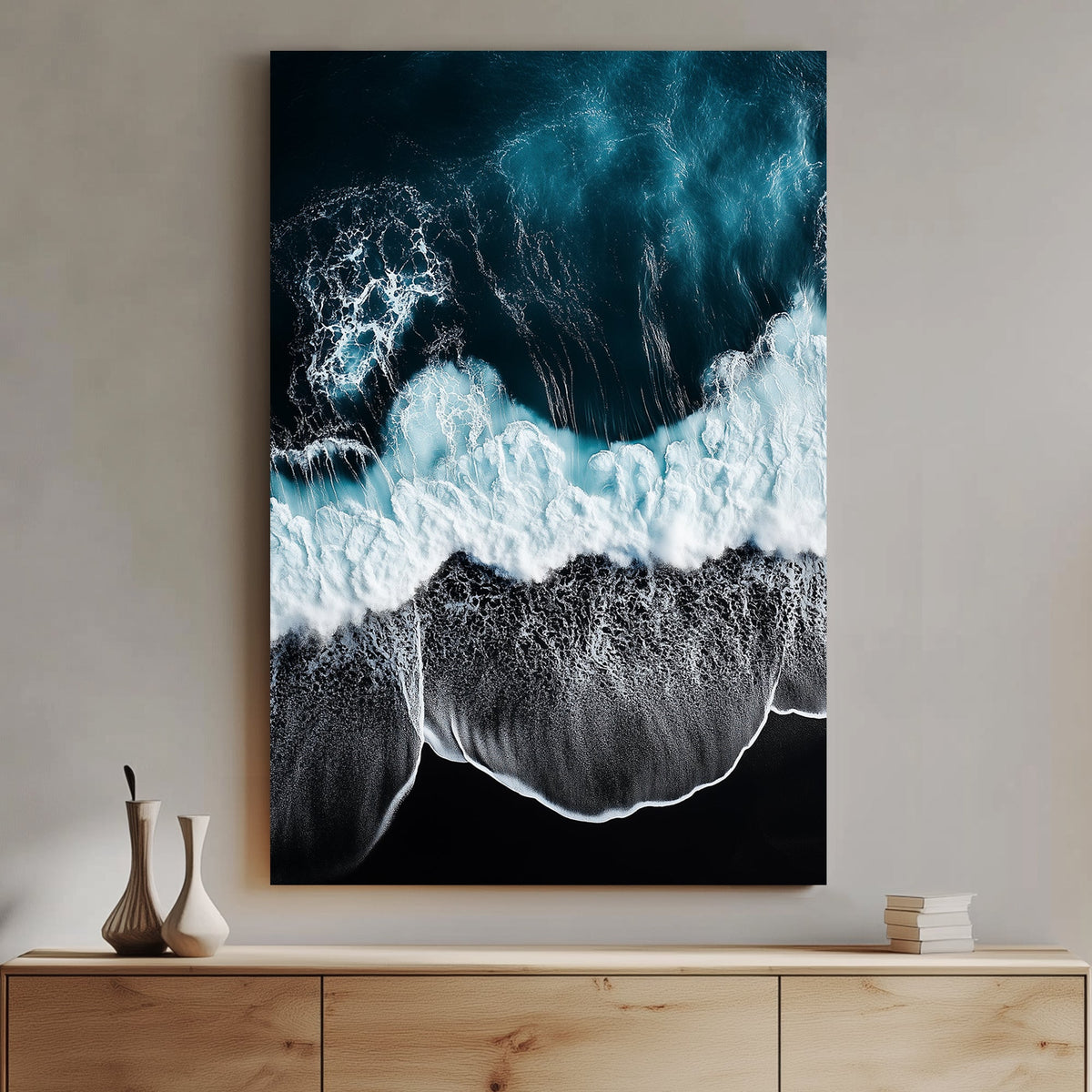Aerial ocean wall art with deep blue waves crashing onto a black sand beach.
