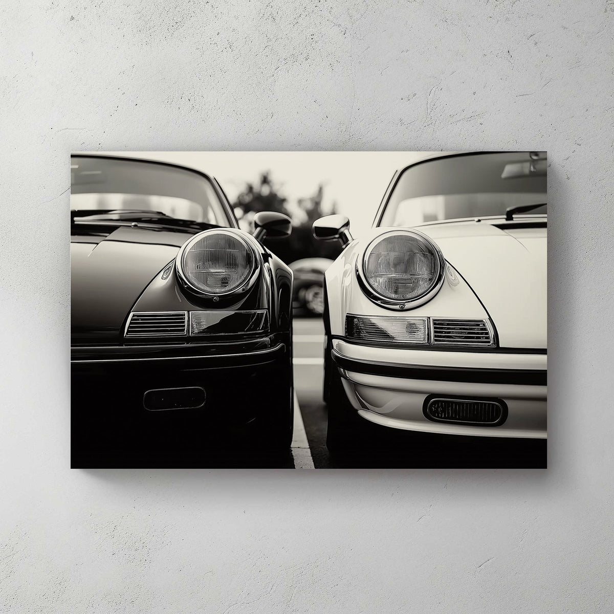 Black and white wall art featuring two vintage Porsche 911 cars parked side by side in a striking monochrome composition.