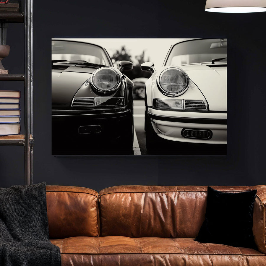 Black and white wall art featuring two vintage Porsche 911 cars parked side by side in a striking monochrome composition.