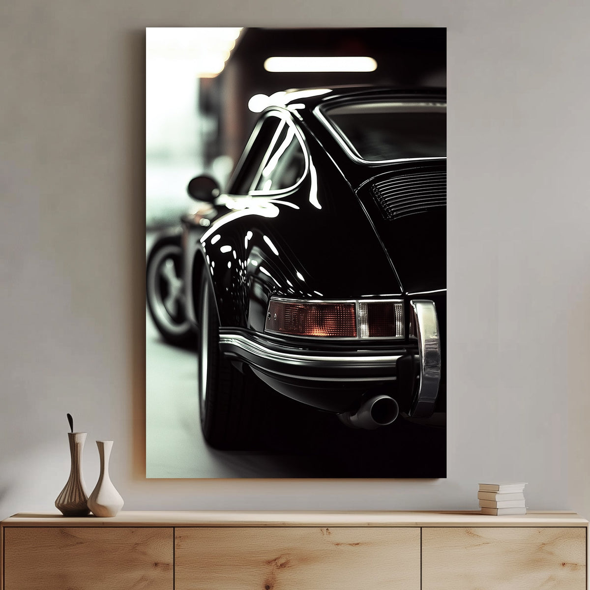 Close-up of a classic black Porsche with reflective chrome details in a dimly lit garage.