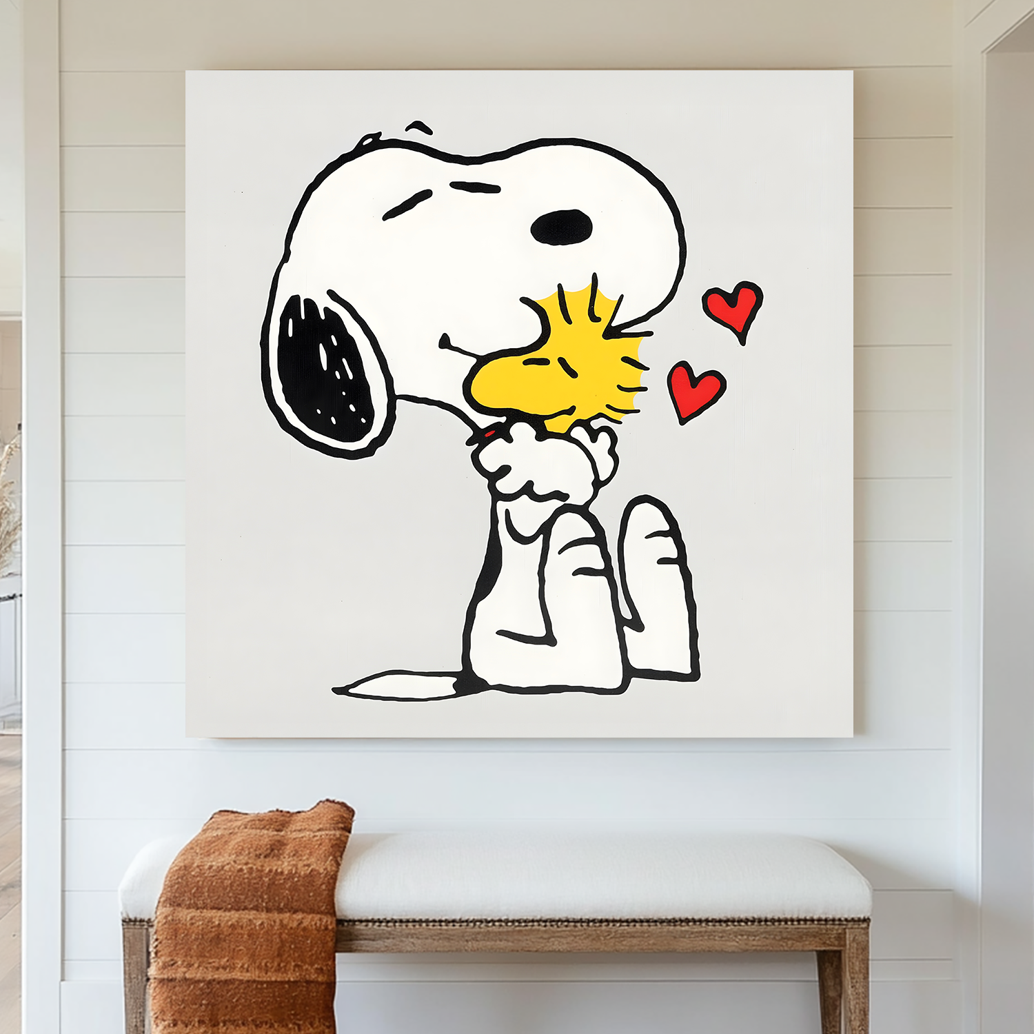 A piece of wall art featuring cartoon characters Snoopy and Woodstock from the Peanuts comic strip, with bold black outlines, crisp white space, and soft pops of color. The artwork shows Snoopy giving Woodstock a hug, with floating hearts in the air.