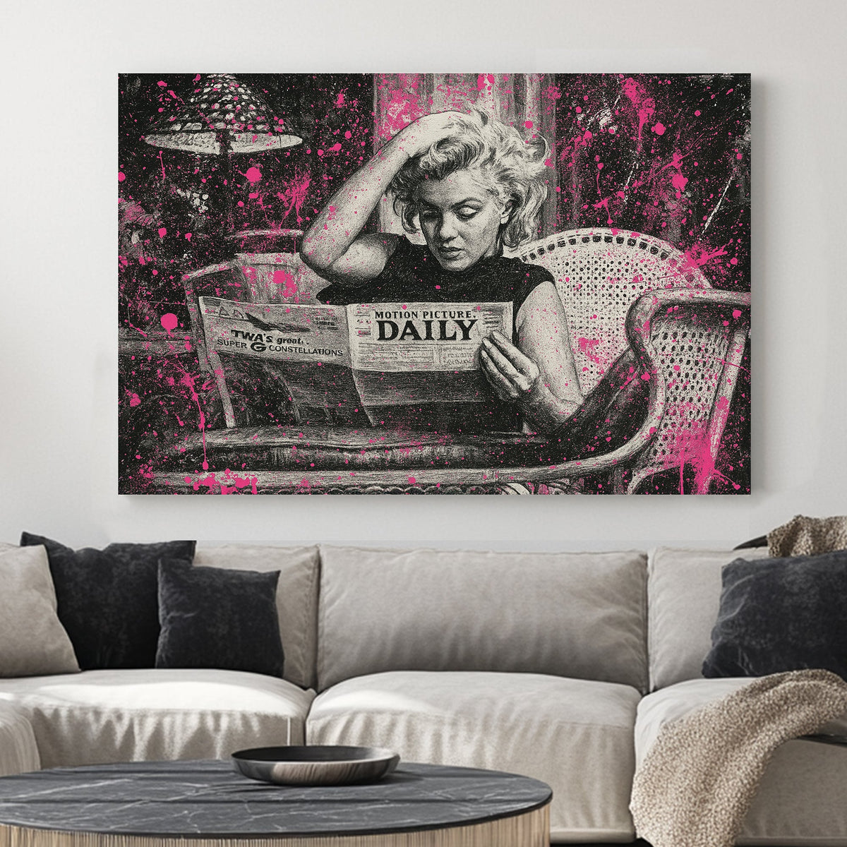 Marilyn Monroe reading newspaper in black and white with pink paint splatter wall art