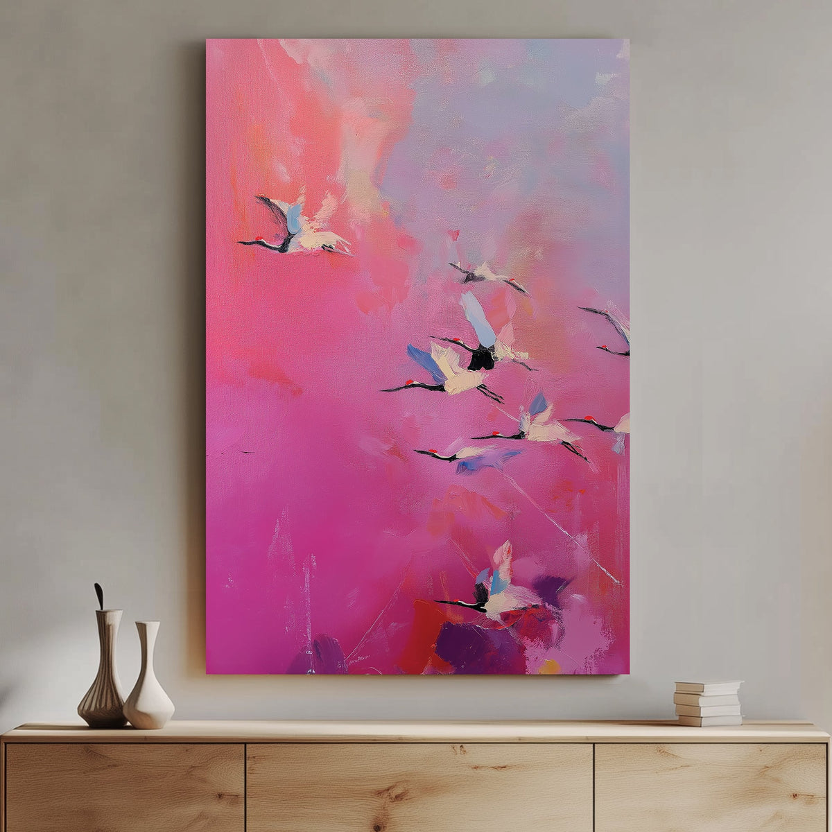 Pink and purple wall art of flying cranes in a dreamy sky