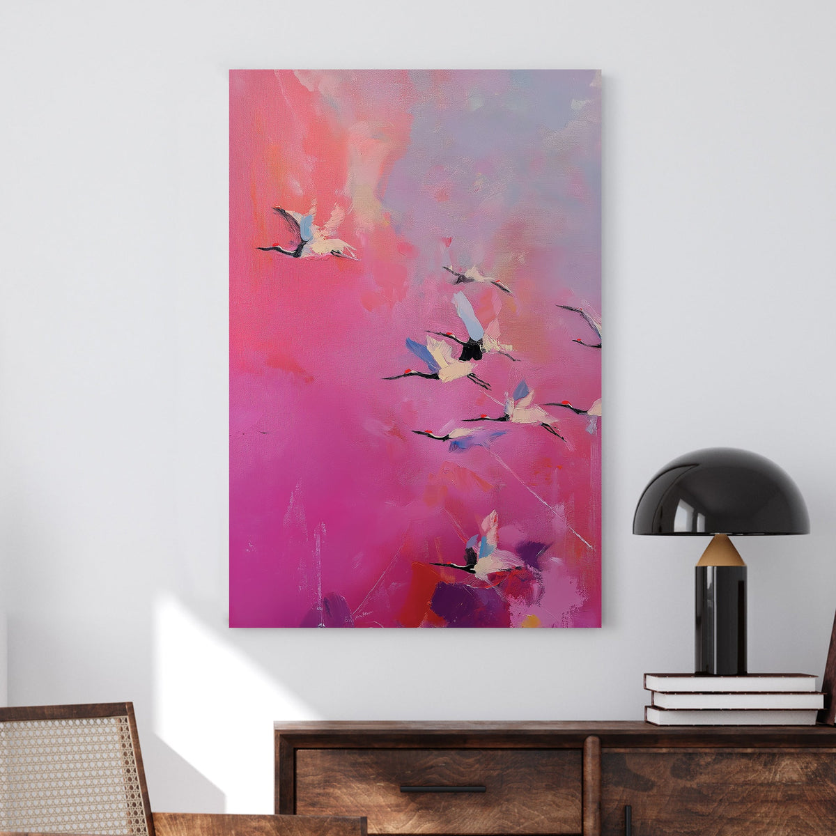 Pink and purple wall art of flying cranes in a dreamy sky