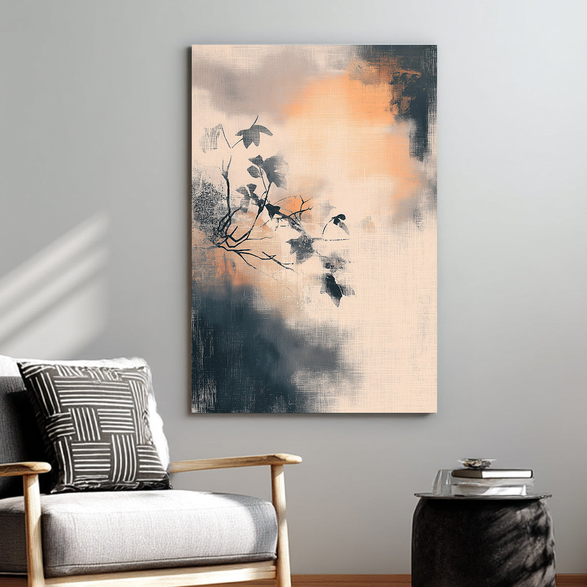 Minimalist wall art of a branch with leaves over a textured, smoky background