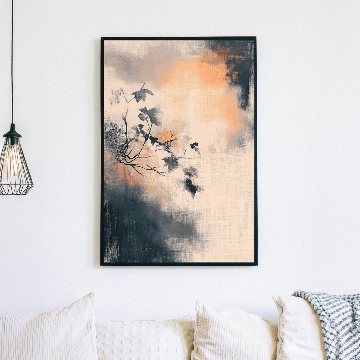 Minimalist wall art of a branch with leaves over a textured, smoky background