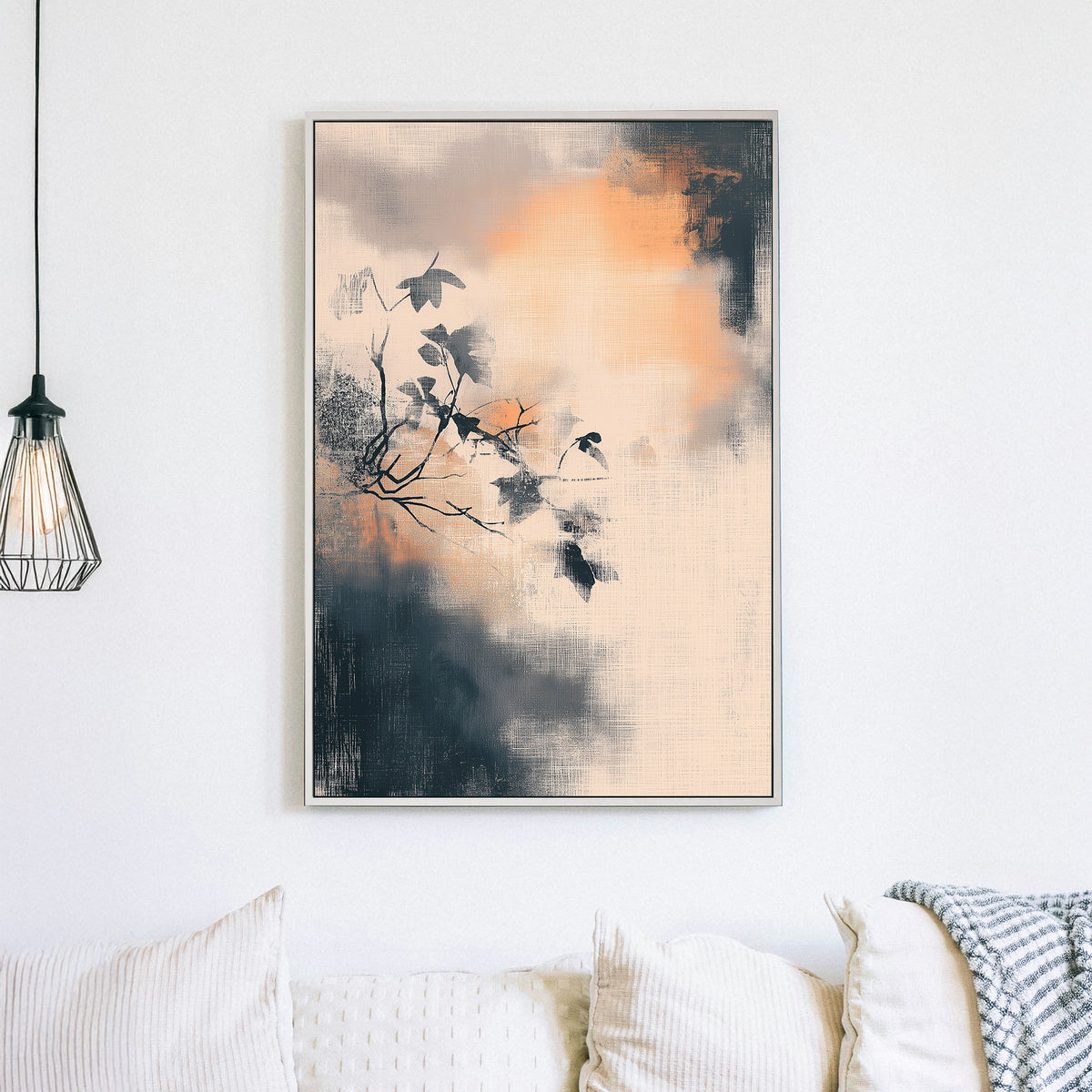 Minimalist wall art of a branch with leaves over a textured, smoky background