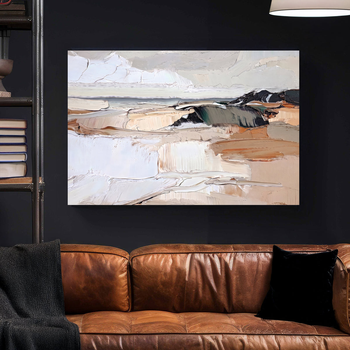 An abstract landscape painting with cream, beige, brown, gray, and black tones, displayed on a dark wall above a brown leather sofa in a modern living room setting.