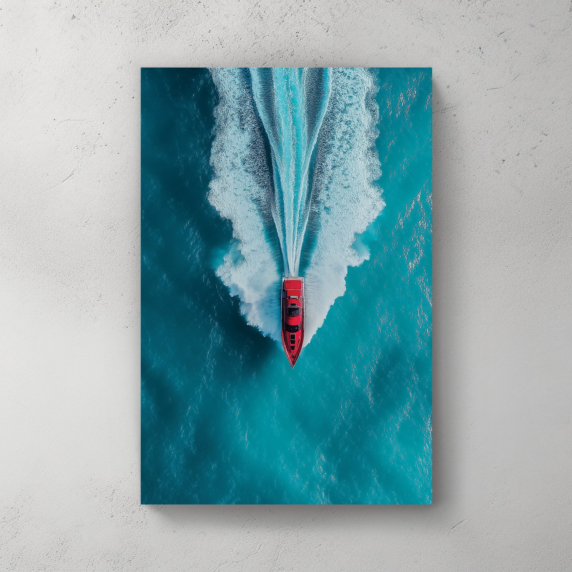 Aerial wall art of red boat speeding across turquoise ocean