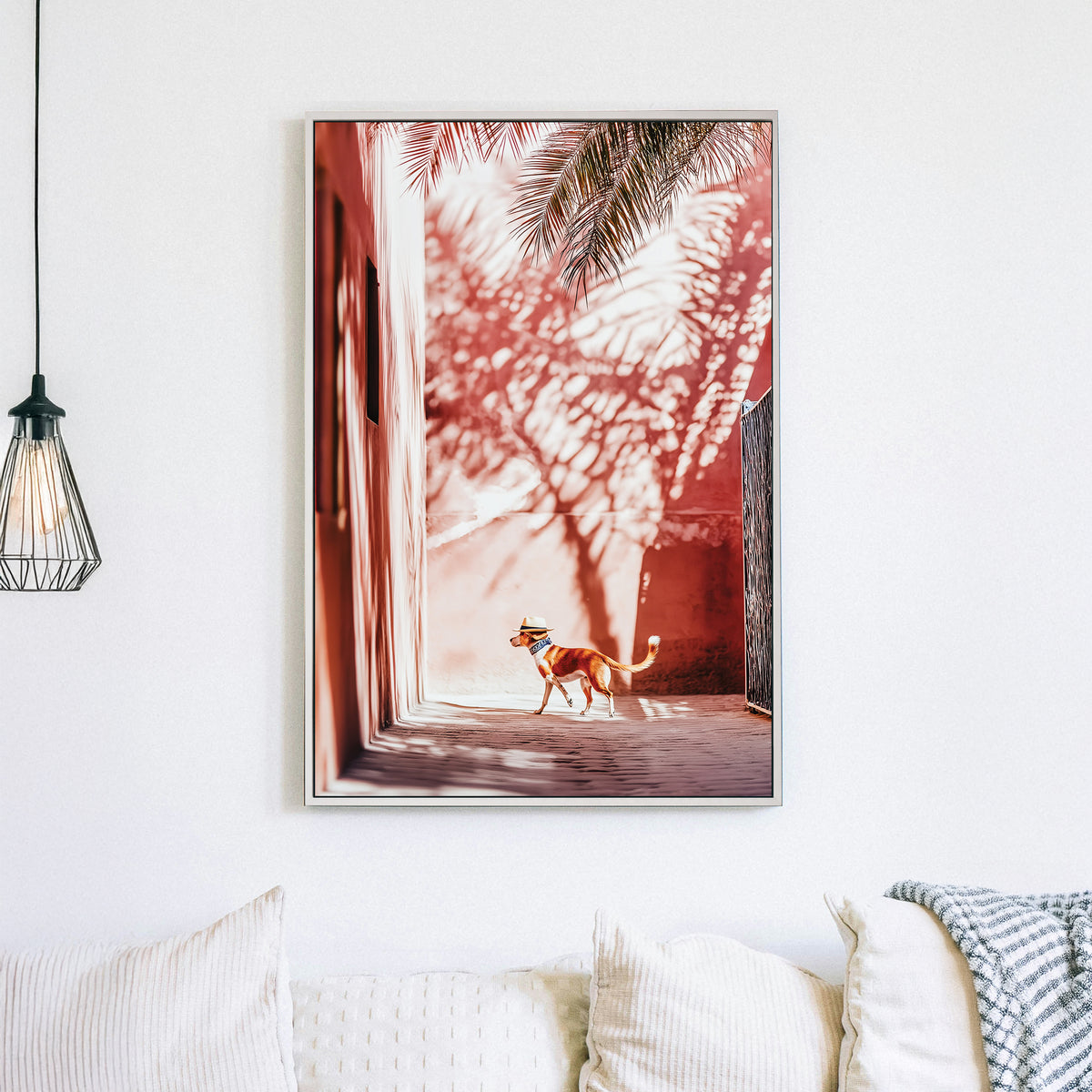 Stylish dog wearing a hat walking through a sunlit alley with palm shadows on pink walls