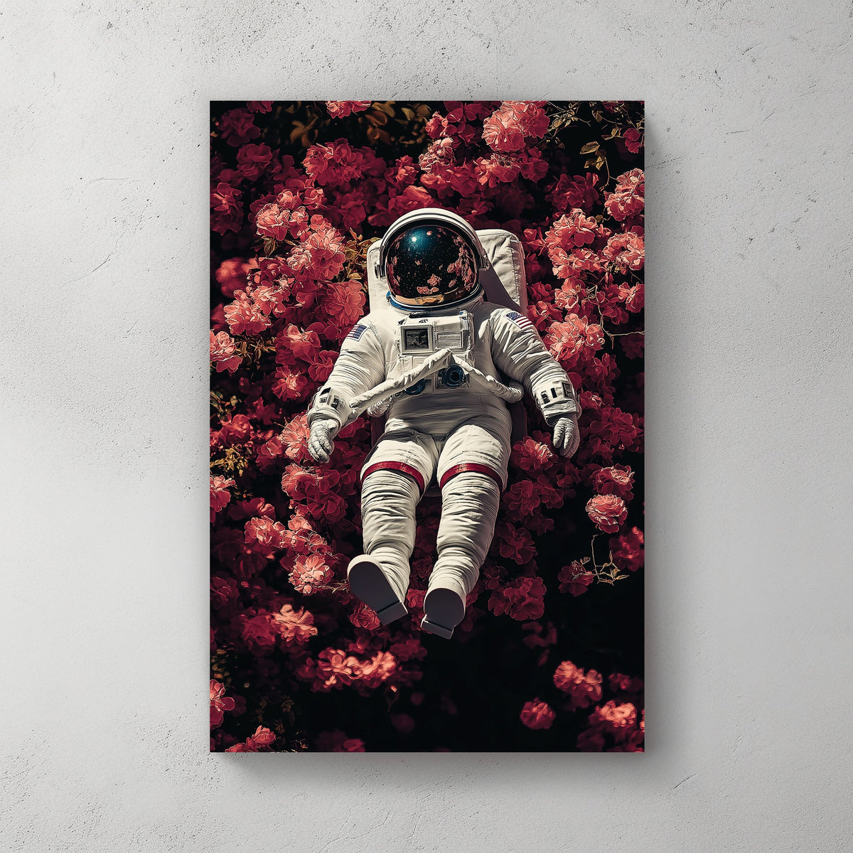 wall art of astronaut resting in a field of pink flowers with galaxy reflection in helmet