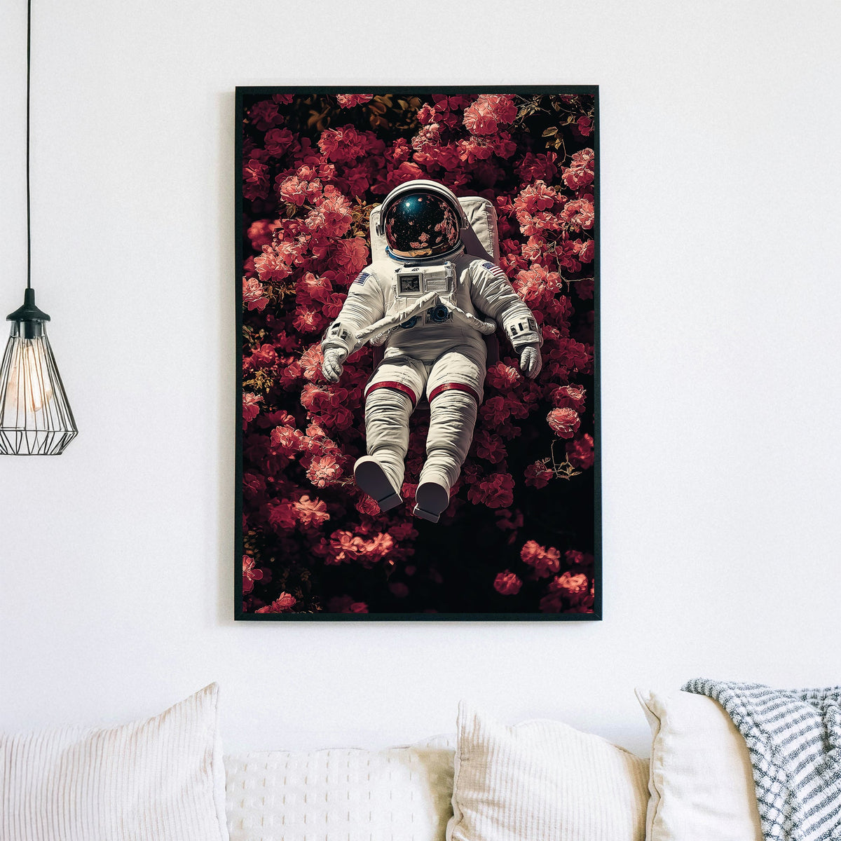 wall art of astronaut resting in a field of pink flowers with galaxy reflection in helmet