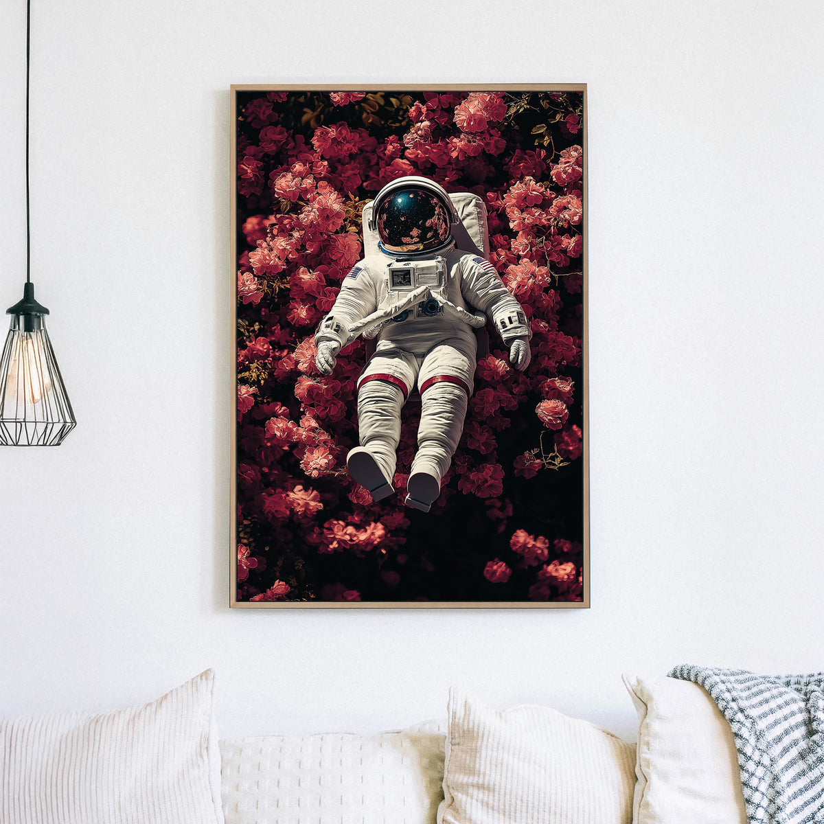 wall art of astronaut resting in a field of pink flowers with galaxy reflection in helmet