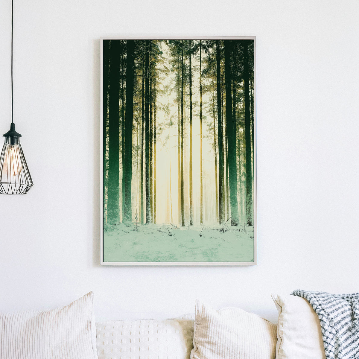 snowy forest with sunlight through pine trees wall art
