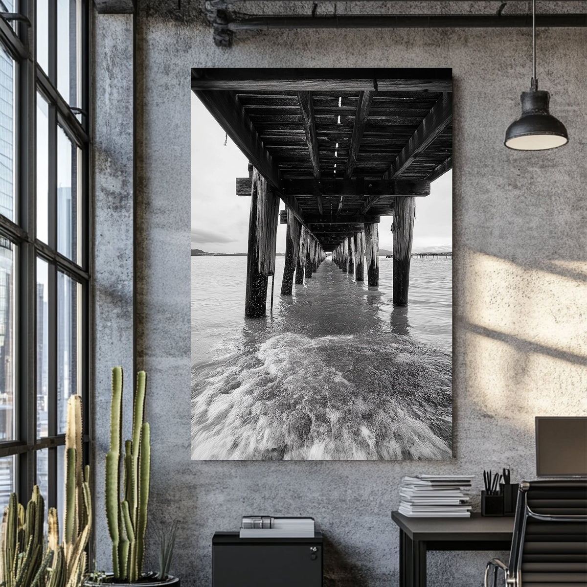 black and white wall art photography of ocean waves under wooden pier with vanishing point perspective
