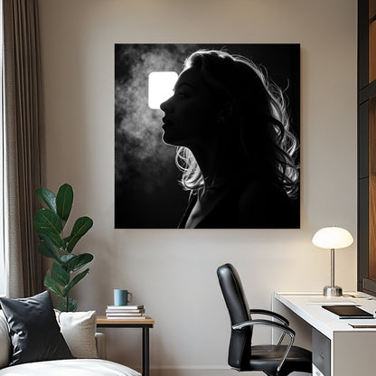 moody black and white wall art of woman exhaling in silhouette with backlight
