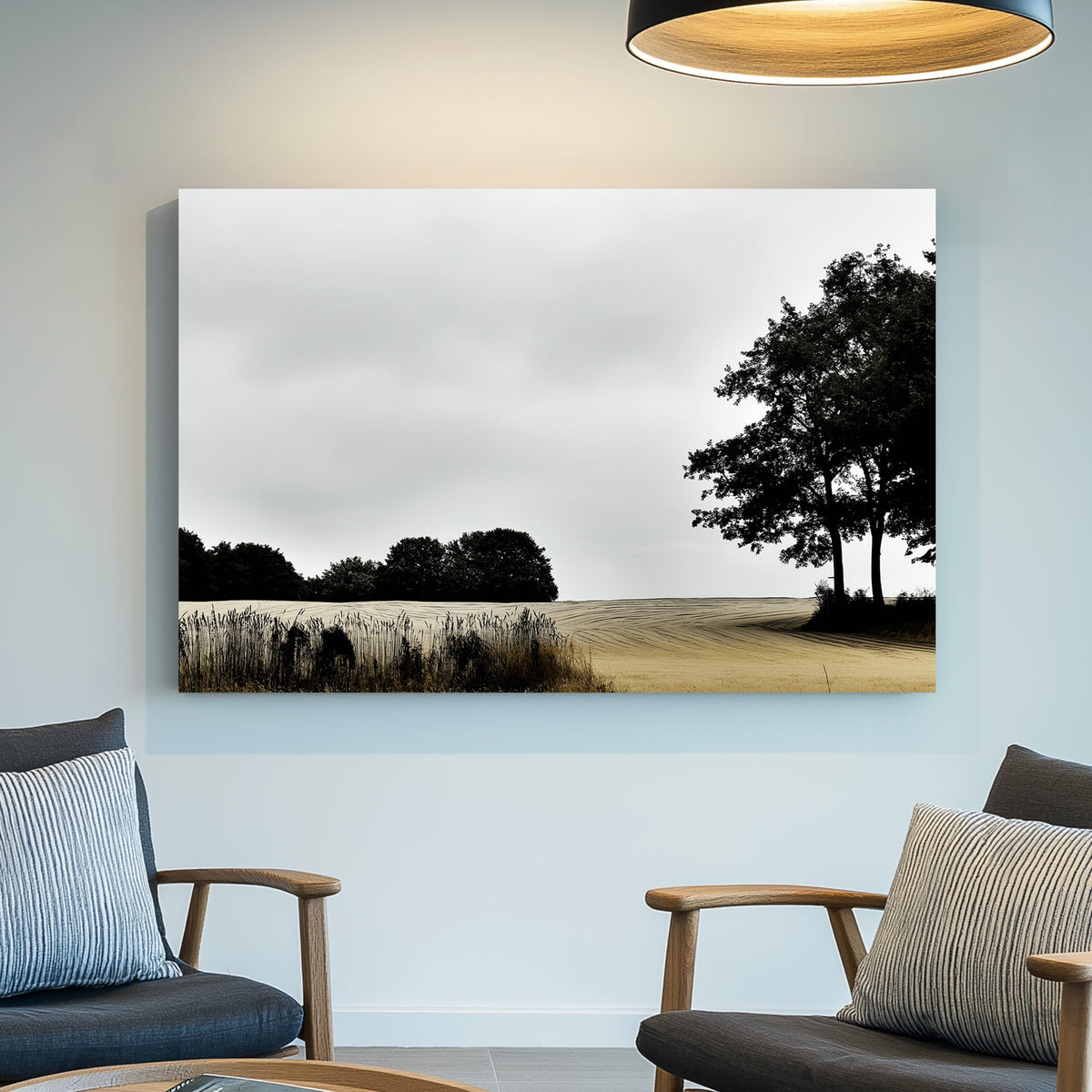 moody rural landscape with trees and curved farmland under grey sky wall art
