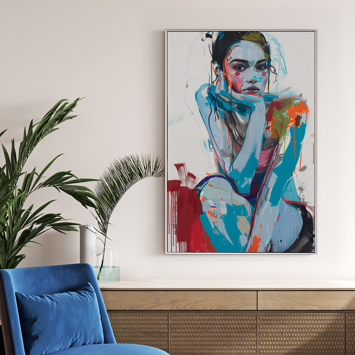 contemporary abstract portrait of woman sitting with chin on hand in bold blue and red
