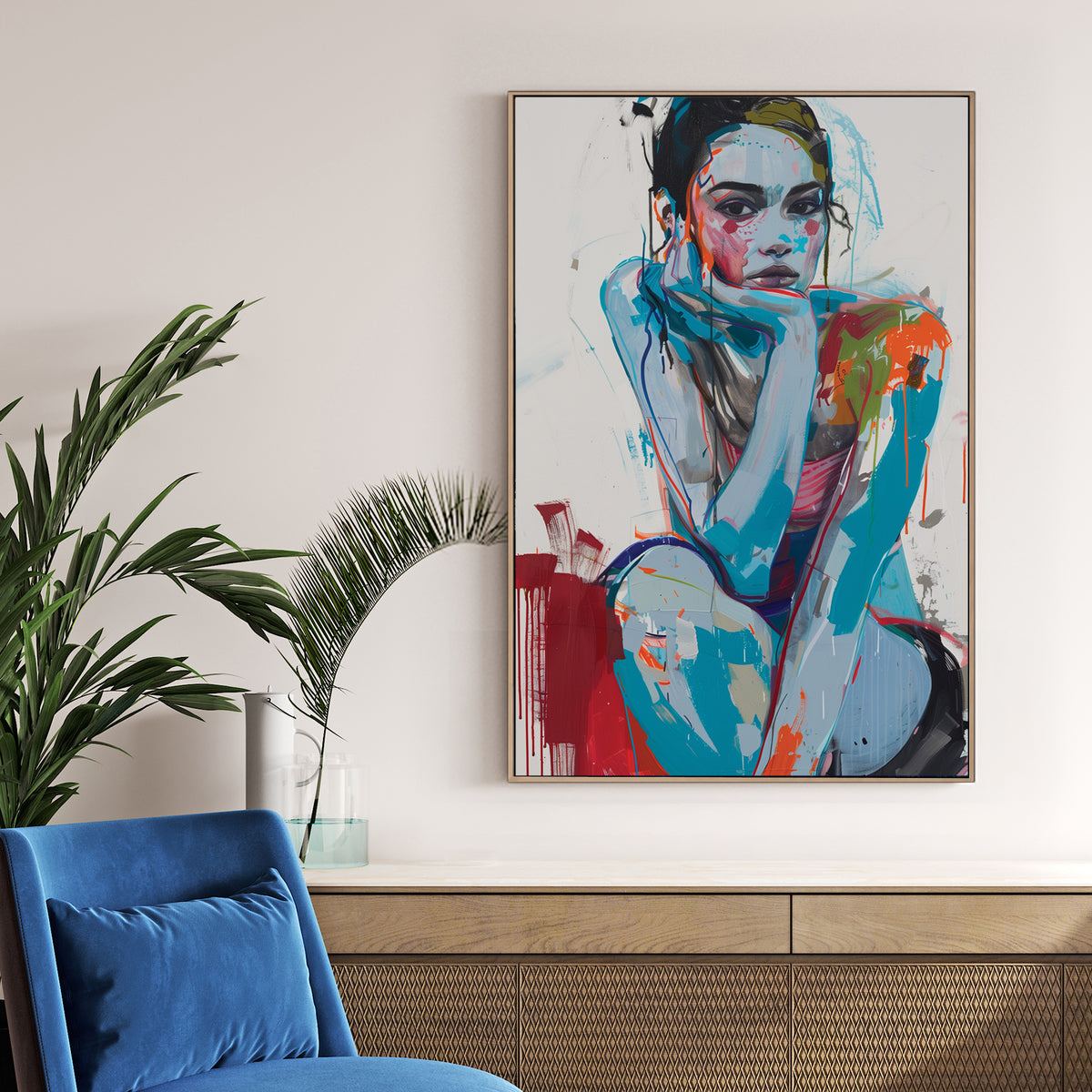 contemporary abstract portrait of woman sitting with chin on hand in bold blue and red
