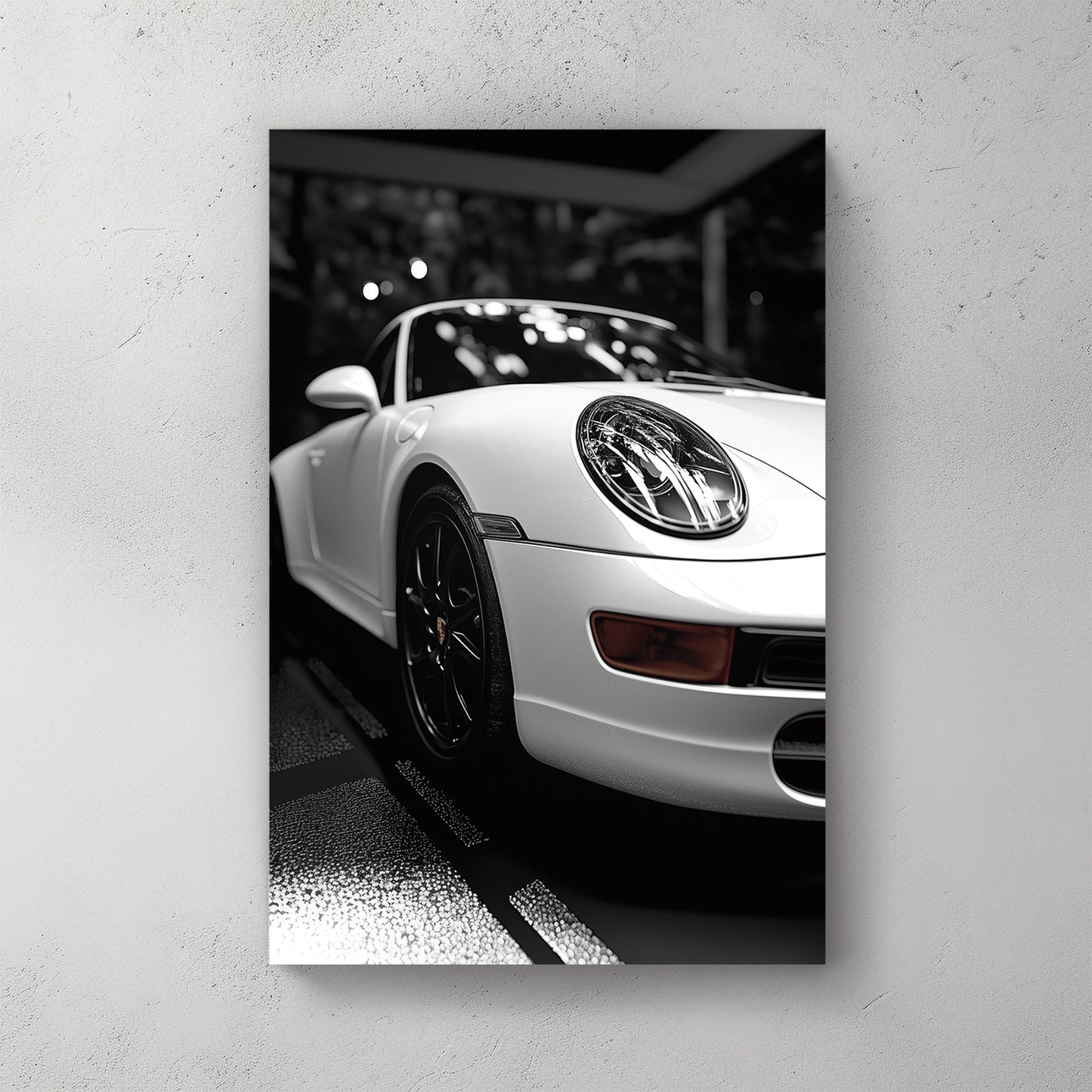 black and white Porsche wall art with dramatic showroom lighting