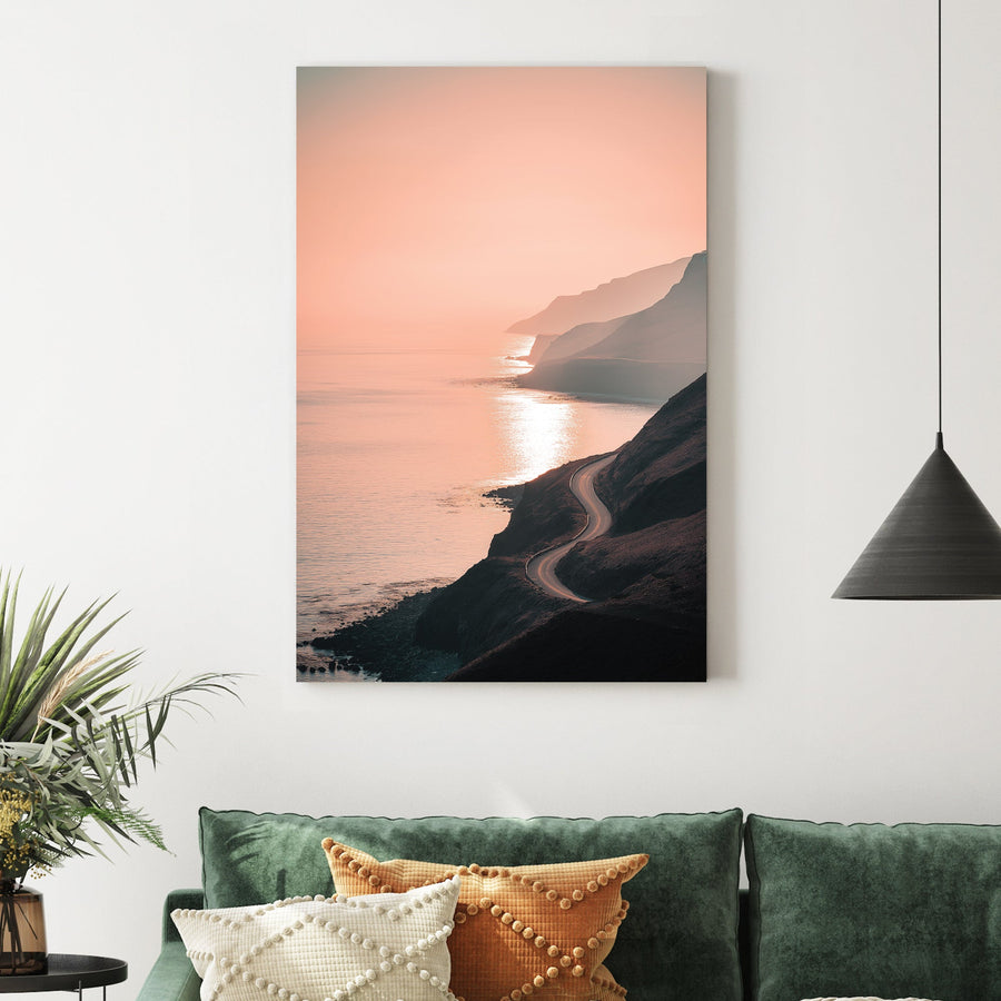 coastal road winding along ocean cliffs at sunset