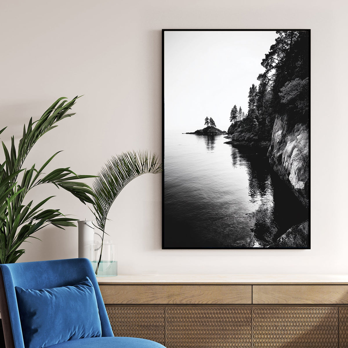 black and white rocky coastline with trees and ocean reflections