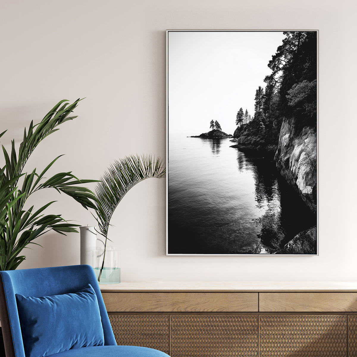 black and white rocky coastline with trees and ocean reflections