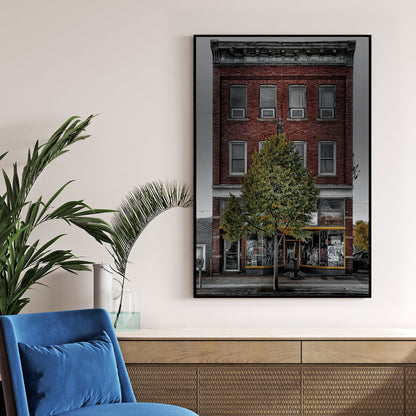 Vintage red-brick storefront with urban posters and single tree, moody sky backdrop