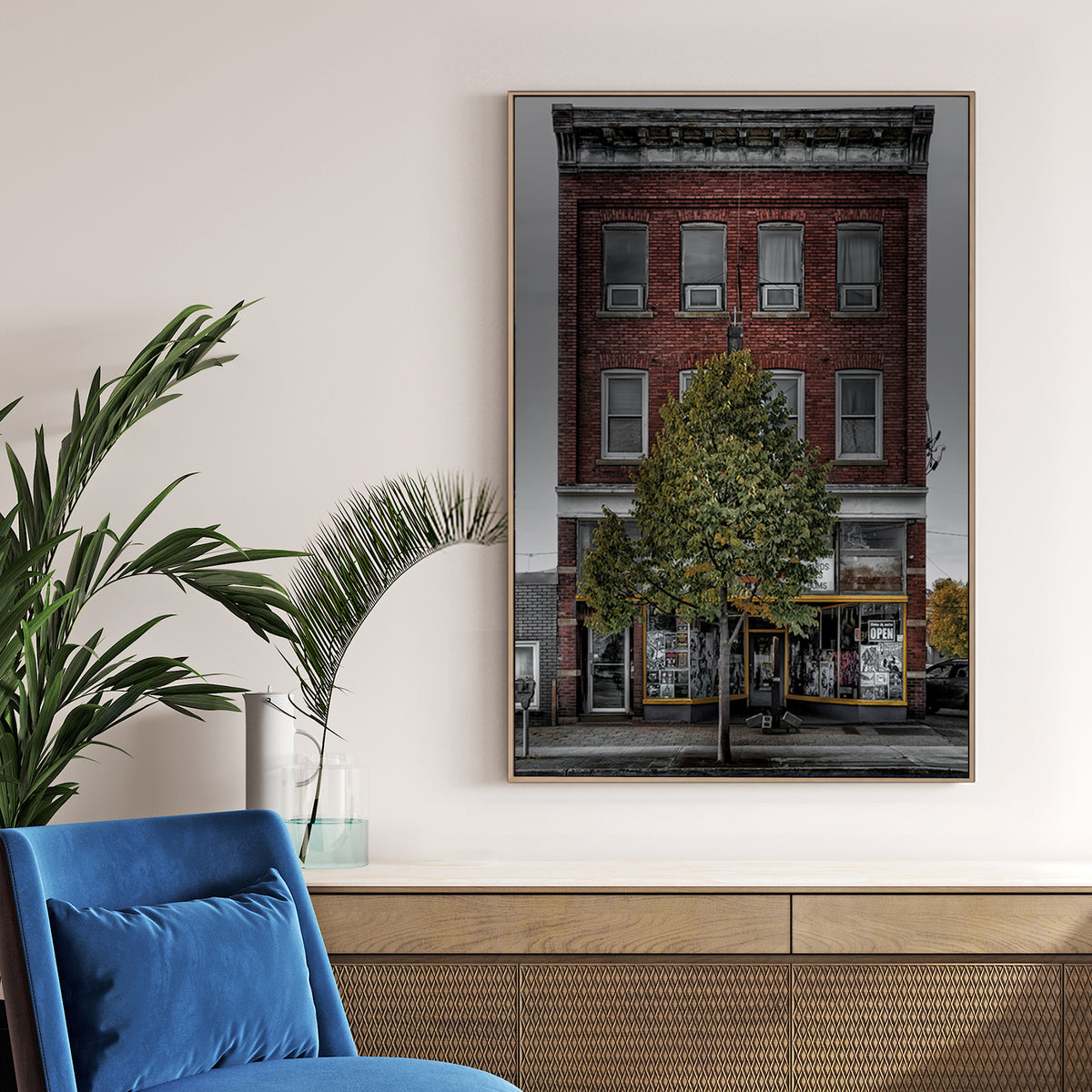 Vintage red-brick storefront with urban posters and single tree, moody sky backdrop