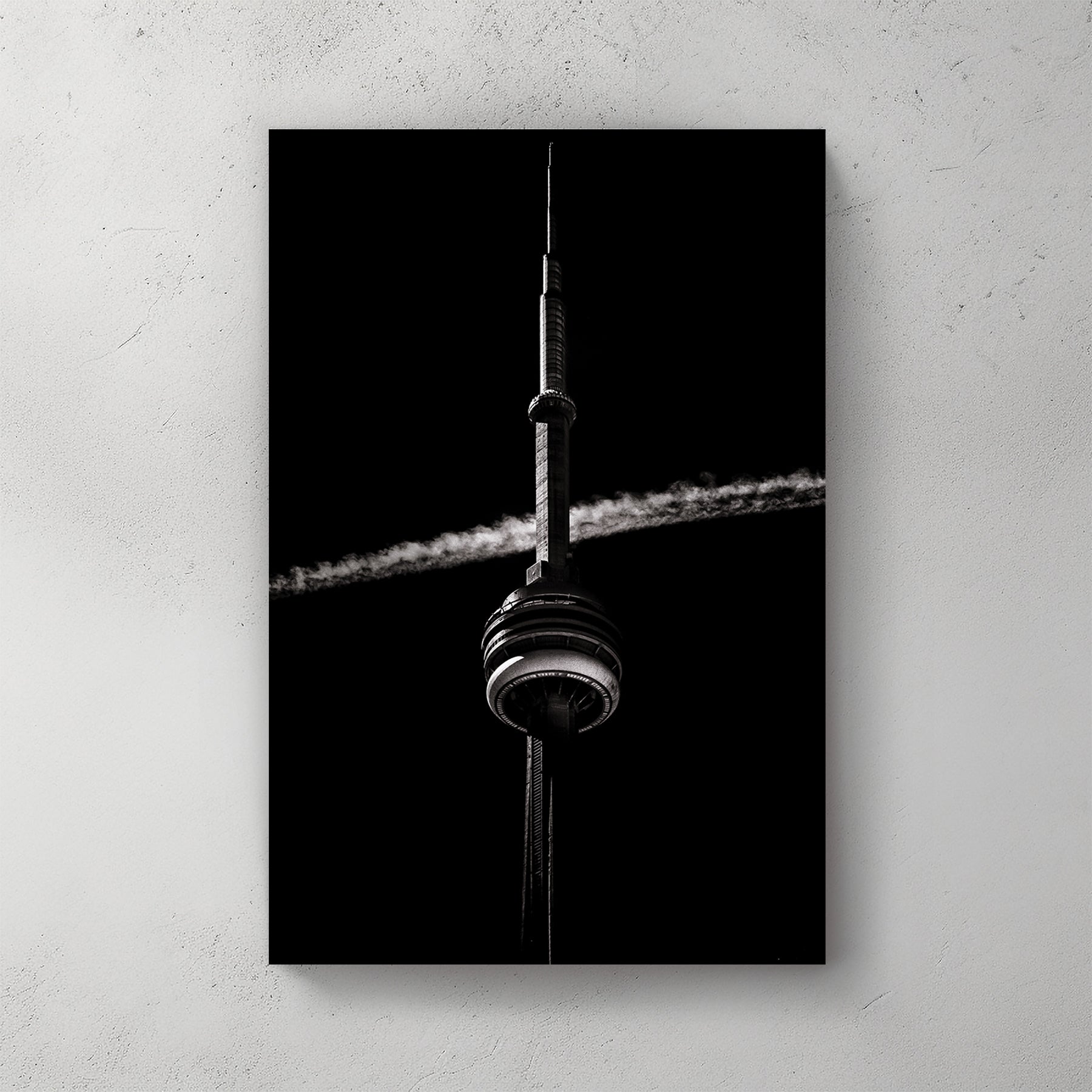 Black and white CN Tower photo with jet trail crossing sky
