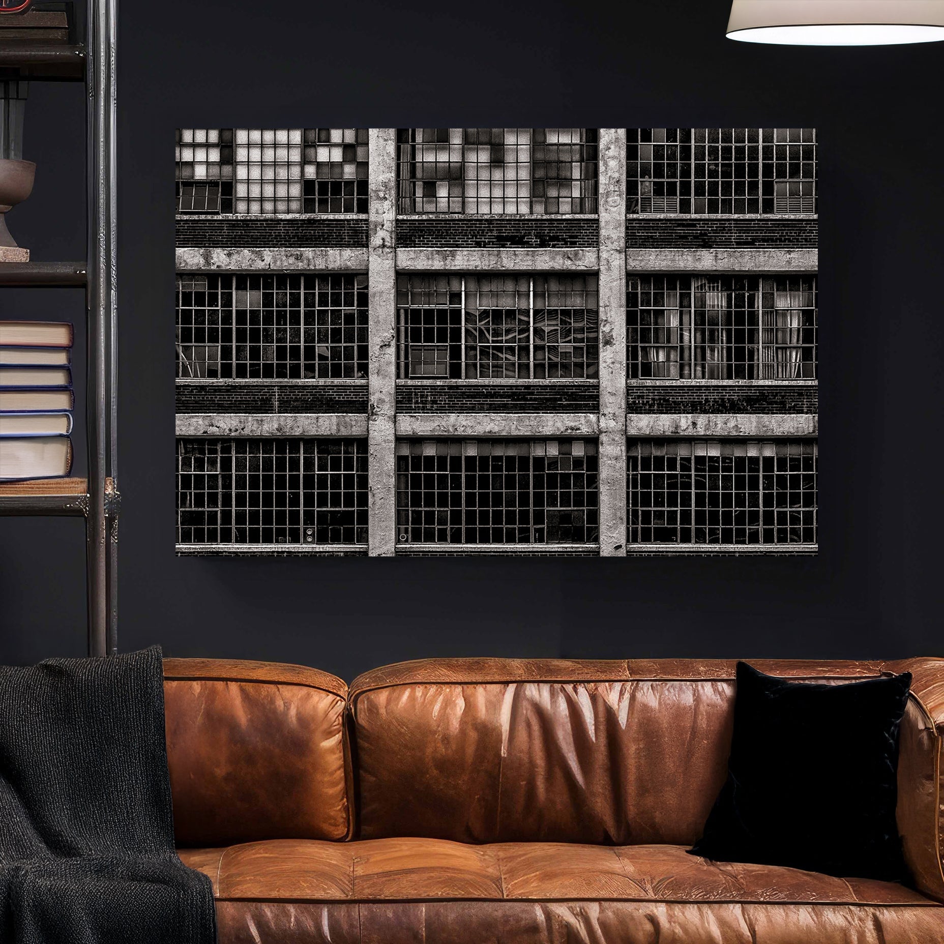 black and white industrial building with broken window panes and symmetrical grid layout