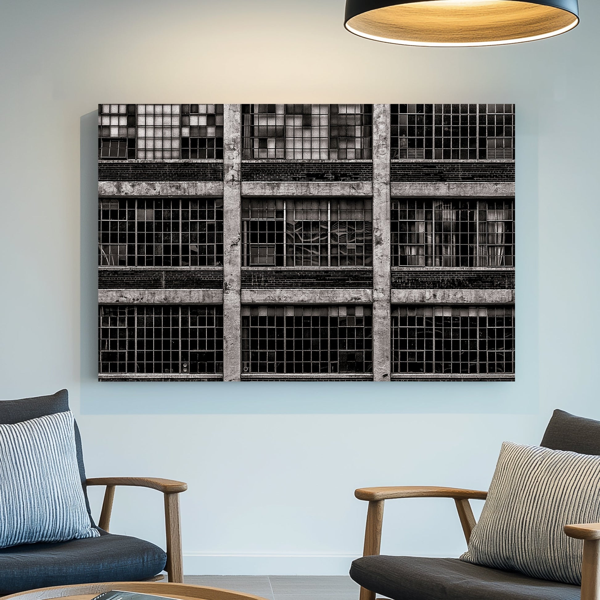 black and white industrial building with broken window panes and symmetrical grid layout