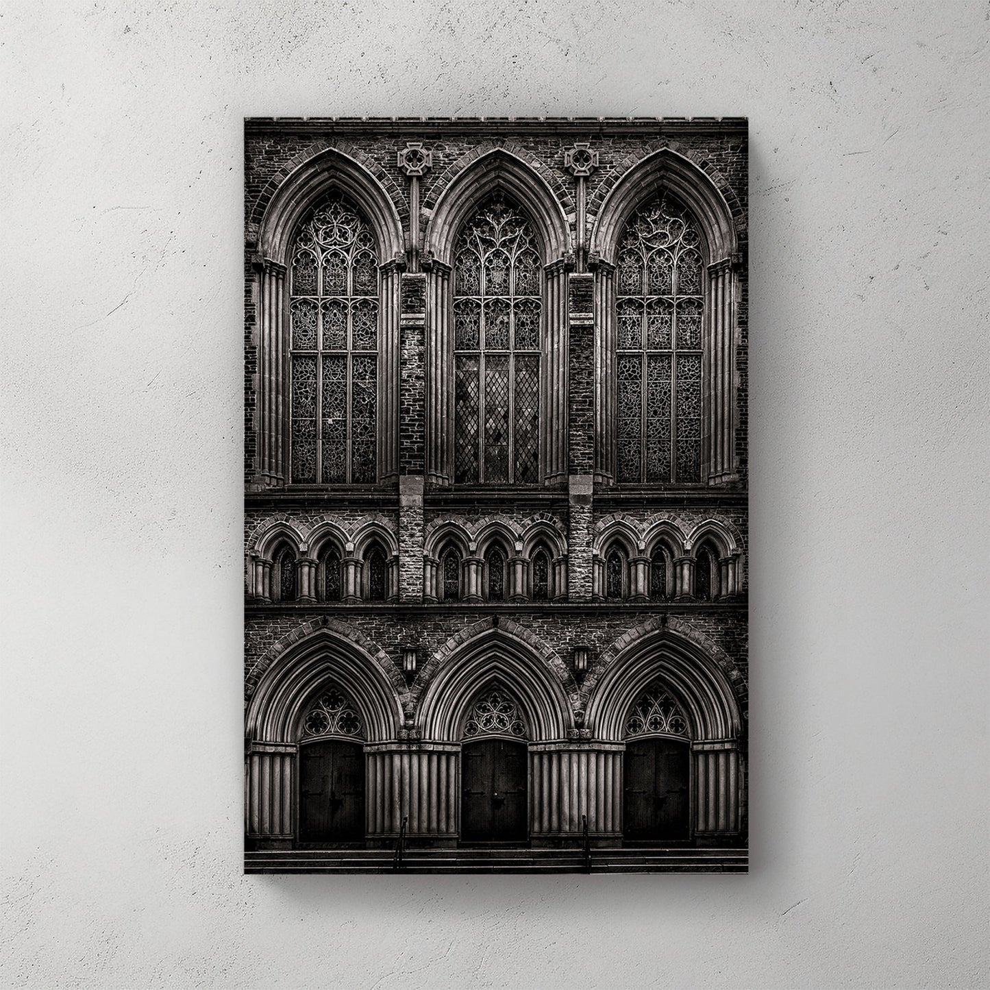 black and white photo of gothic church façade with stained glass windows and arched doors