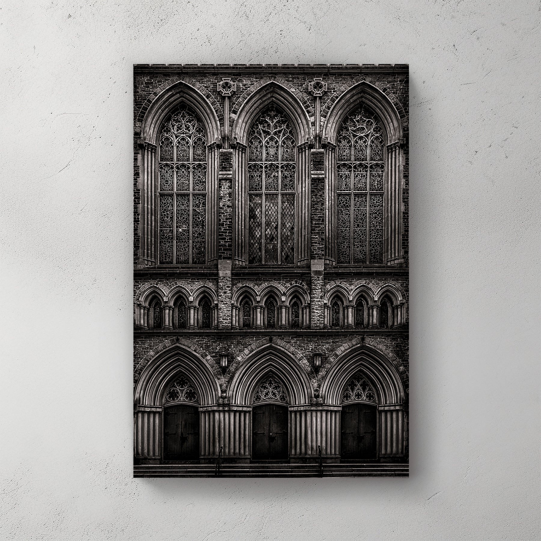 black and white photo of gothic church façade with stained glass windows and arched doors