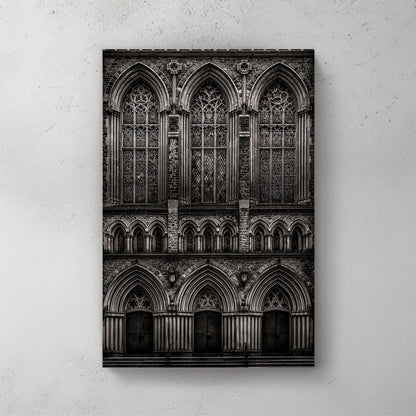 black and white photo of gothic church façade with stained glass windows and arched doors